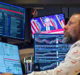 Divided Fed lowers  rates, signals pause